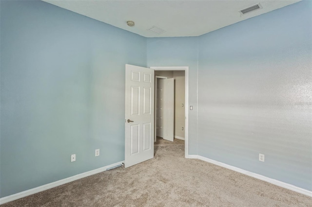 empty room featuring light colored carpet