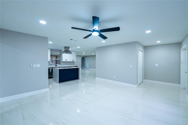 unfurnished living room featuring ceiling fan