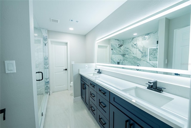 bathroom with vanity, toilet, and an enclosed shower