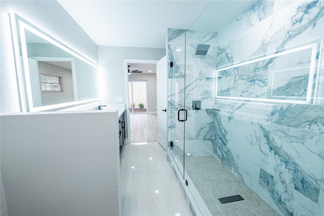 bathroom with vanity, a shower with door, and ceiling fan