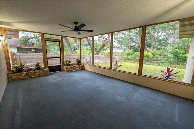 unfurnished sunroom featuring ceiling fan