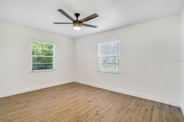 unfurnished room with ceiling fan, plenty of natural light, and light wood-type flooring