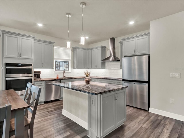 3286 Hanging Tide St, Winter Garden, FL 34787 - kitchen featuring appliances with stainless steel finishes, wall chimney exhaust hood, gray cabinets, a sink, and dark wood finished floors