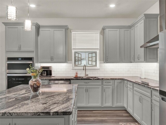 3286 Hanging Tide St, Winter Garden, FL 34787 - kitchen with a sink, stainless steel appliances, dark stone countertops, backsplash, and recessed lighting