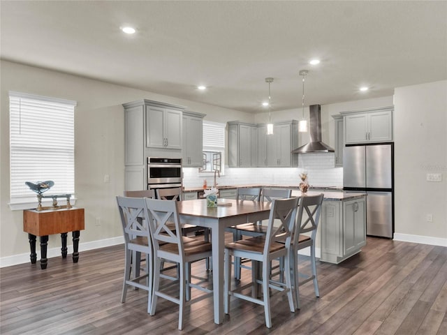 dining area featuring dark wood-type flooring and sink