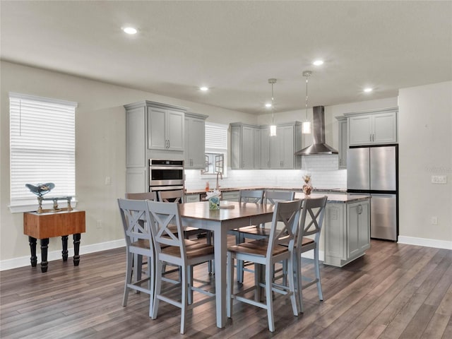 3286 Hanging Tide St, Winter Garden, FL 34787 - kitchen featuring wall chimney exhaust hood, stainless steel appliances, gray cabinets, dark wood-type flooring, and recessed lighting