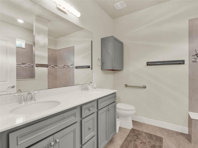 bathroom featuring toilet, vanity, and tile patterned floors