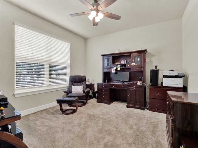 carpeted office space with ceiling fan and plenty of natural light