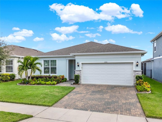 ranch-style home featuring a garage and a front lawn