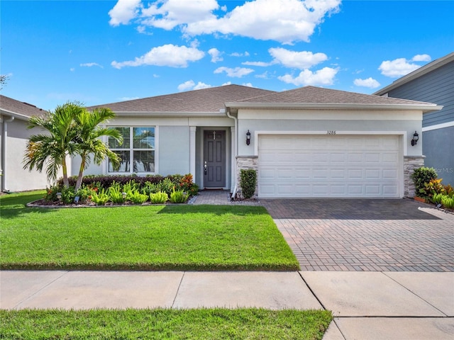 3286 Hanging Tide St, Winter Garden, FL 34787 - ranch-style home with stucco siding, decorative driveway, stone siding, and an attached garage