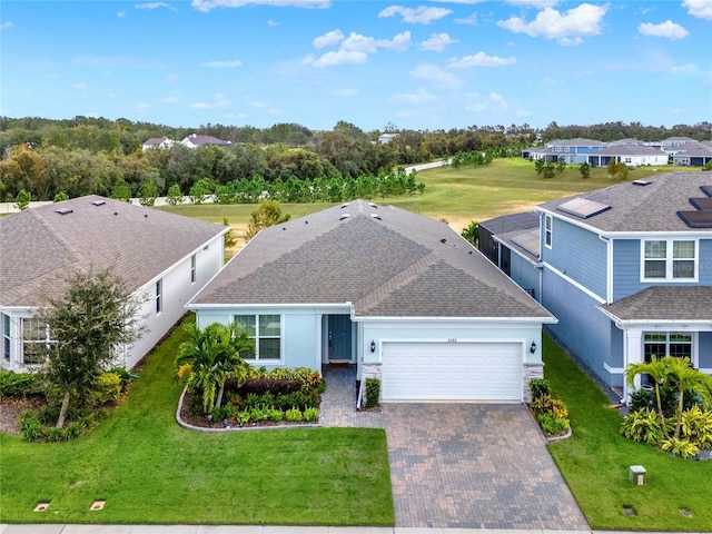3286 Hanging Tide St, Winter Garden, FL 34787 - view of front of house with an attached garage, a shingled roof, decorative driveway, and a front lawn