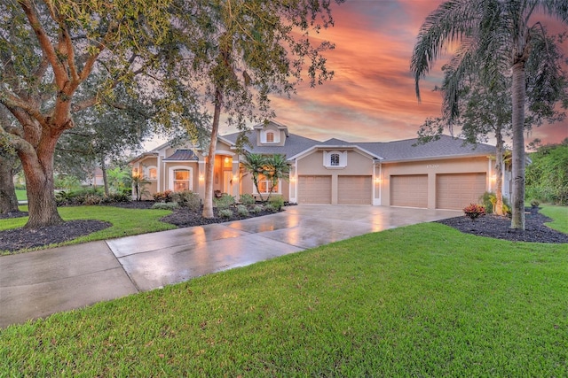 view of front of house featuring a yard and a garage