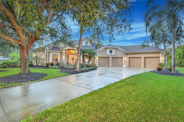 view of front of house featuring a front yard and a garage