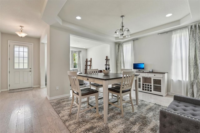 dining area featuring an inviting chandelier and light hardwood / wood-style flooring