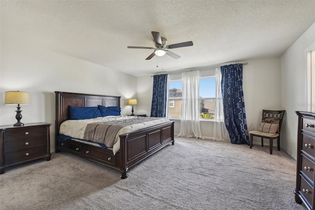 bedroom featuring ceiling fan, a textured ceiling, and light colored carpet