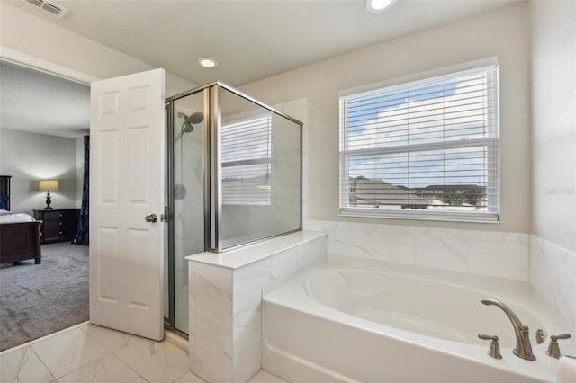 bathroom featuring independent shower and bath