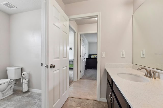 bathroom featuring wood-type flooring, vanity, and toilet