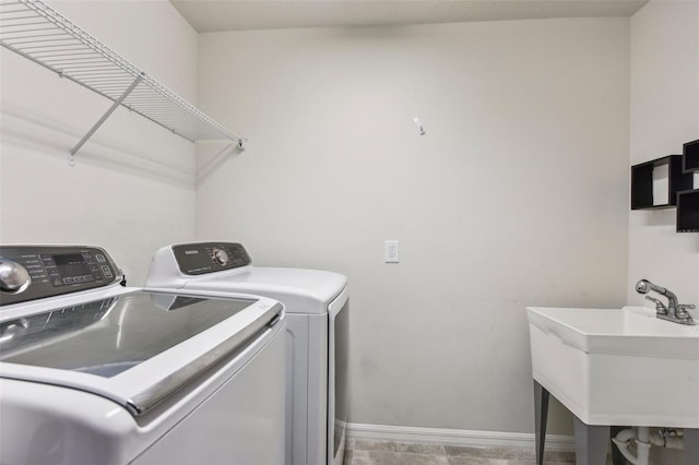 clothes washing area with tile patterned floors, sink, and independent washer and dryer