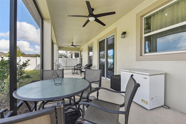 sunroom featuring ceiling fan