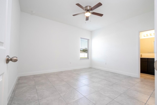 tiled spare room with ceiling fan