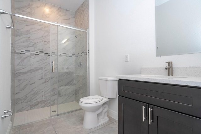 bathroom featuring a shower with door, vanity, toilet, and tile patterned floors