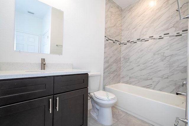 full bathroom featuring vanity, toilet, tiled shower / bath combo, and tile patterned flooring