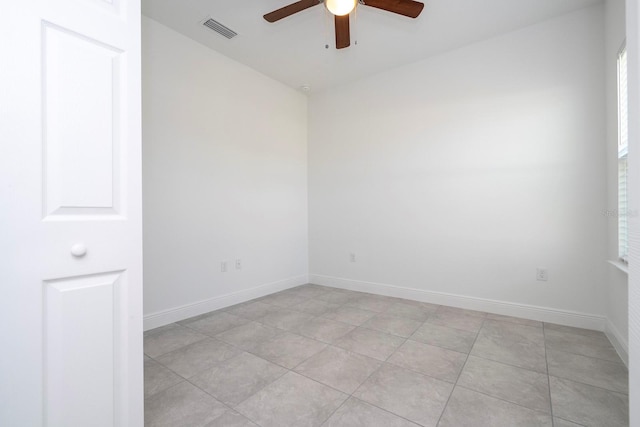 tiled empty room with ceiling fan