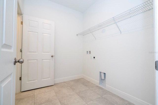 washroom with hookup for an electric dryer, hookup for a washing machine, and light tile patterned floors