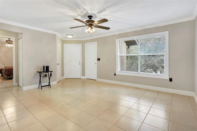 tiled spare room featuring ceiling fan and ornamental molding