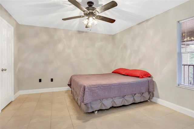 tiled bedroom featuring ceiling fan