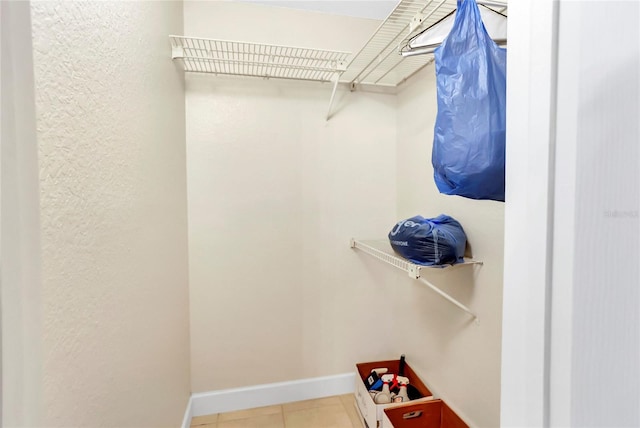 walk in closet with tile patterned floors