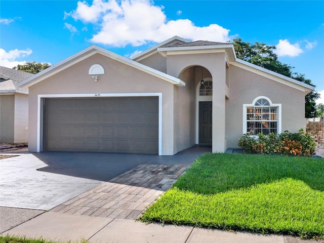 view of front of home with a garage and a front lawn