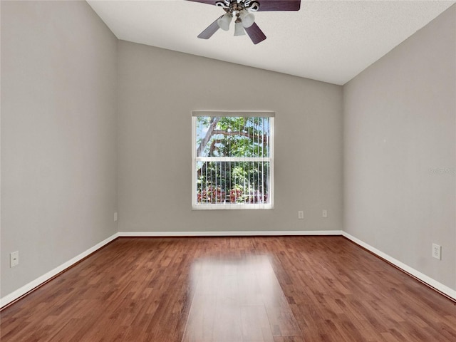 spare room featuring hardwood / wood-style floors, ceiling fan, a textured ceiling, and lofted ceiling