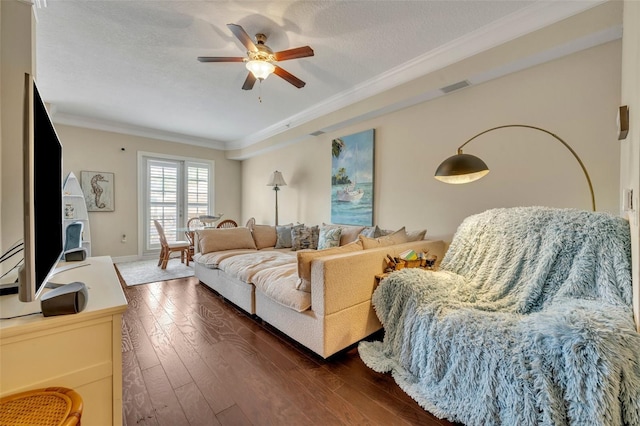 living room with ceiling fan, dark hardwood / wood-style floors, a textured ceiling, and crown molding