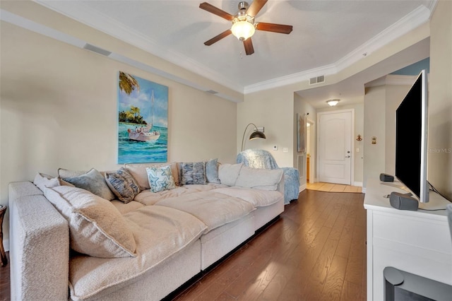 bedroom with dark wood-type flooring, ornamental molding, and ceiling fan