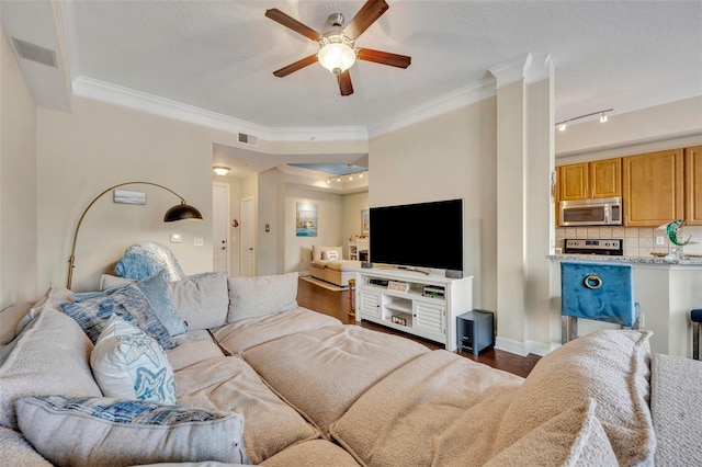 living room with dark wood-type flooring, ceiling fan, a textured ceiling, and ornamental molding