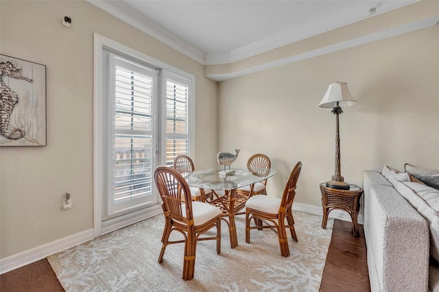 dining space featuring ornamental molding and wood-type flooring