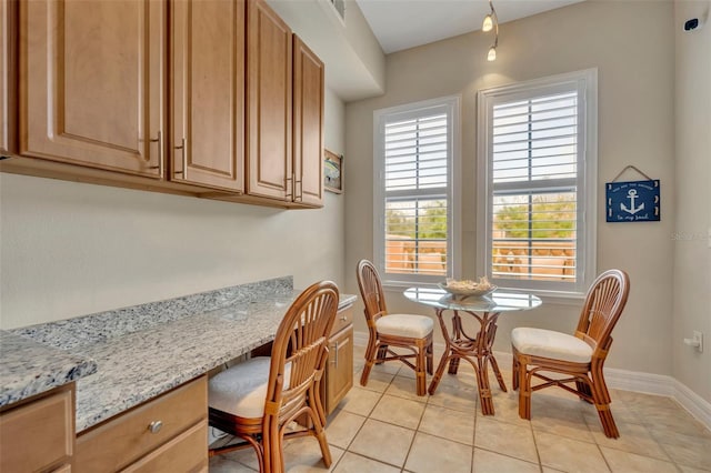 dining area with light tile patterned floors and built in desk