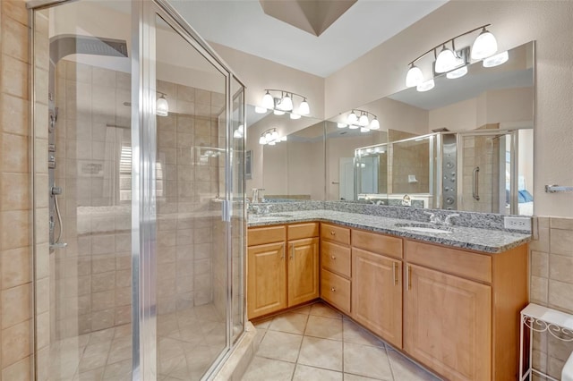 bathroom featuring vanity, tile patterned floors, and a shower with door