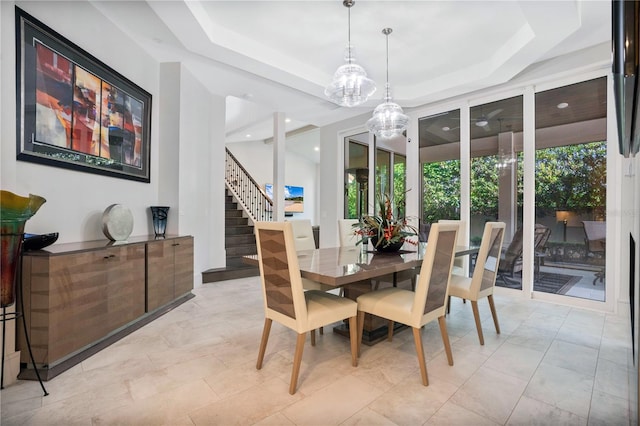 dining area with a raised ceiling