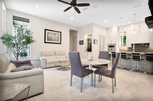 tiled dining area with ceiling fan