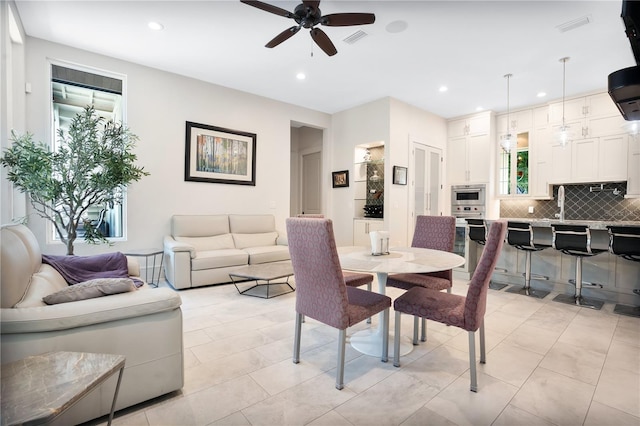 dining space featuring ceiling fan and light tile patterned flooring