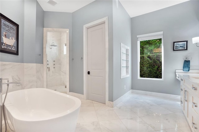 bathroom with vanity and independent shower and bath