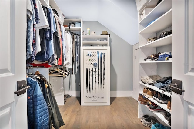 spacious closet featuring lofted ceiling and light wood-type flooring