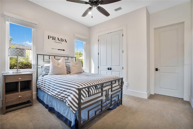 bedroom with carpet floors, a closet, and ceiling fan