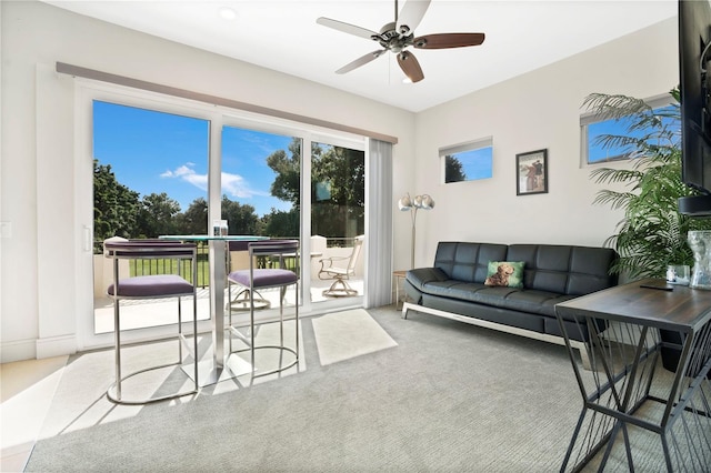 carpeted living room featuring ceiling fan