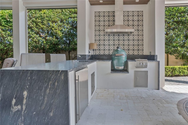 view of patio with a grill, area for grilling, and sink