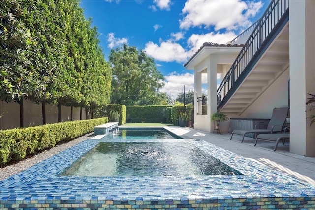 view of swimming pool with a jacuzzi and a patio