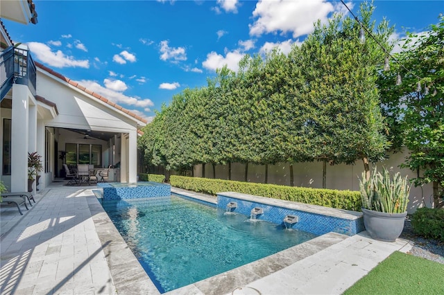 view of swimming pool featuring a patio, pool water feature, and ceiling fan