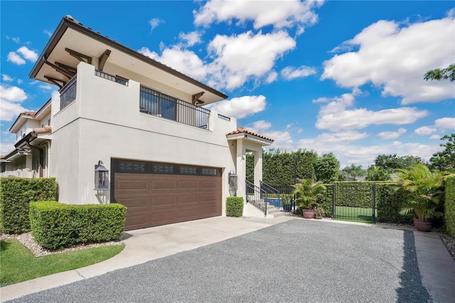 view of front of house with a balcony and a garage